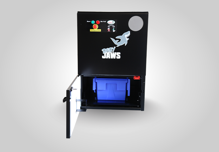 Compact BB01 ‘Baby Jaws’ glass crusher installed behind a bar, powered by single-phase 13 Amp plug.