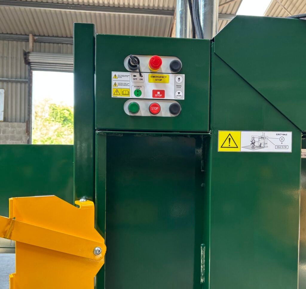 close up of control panel on baler with emergency stop button
